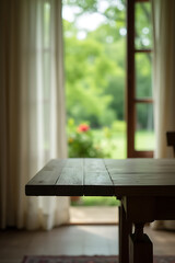 Poster - A wooden table sits atop a blurred curtain with a view of greenery through a window surrounded by trees in a garden setting._00001_