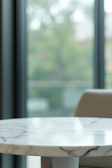 Poster - A selectively focused image of a marble table top against a blurred abstract window glass background._00001_