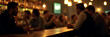 © fotoluigi868 - A photograph shows a blurry image of people drinking at night in a dimly lit bar with a vintage wooden counter._00003_