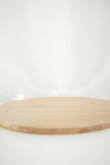 Poster - A minimalist wooden tabletop sits atop a soft focus white background with subtle hints of blur and texture surrounding it._00001_