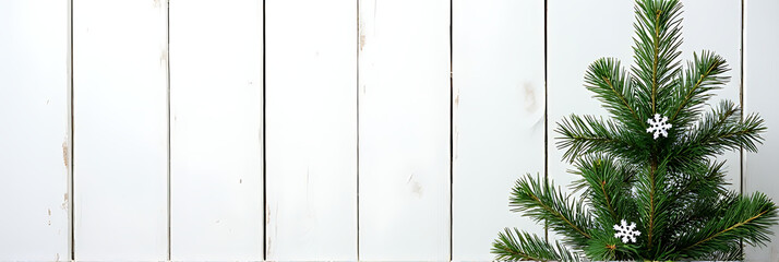 Wall Mural - a christmas fir tree is beautifully decorated with snowflakes and a pine branch, set against a white