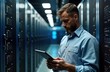 © miss irine - Man in data center checks digital tablet. Tech support specialist checking server details. Inside large tech facility. Examines tech information. Cloud computing professional in data processing