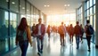 © miss irine - Many students walk in university hallway. Busy day at campus. Students in motion. Indoor setting with large windows. Back-to-school day regular campus day. People walking in corridor. Casual wear,