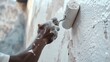 © Jafree - African American Construction Worker Painting a Wall, Emphasizing Hard Work, Skilled Labor, Home Improvement, and the Art of Renovation