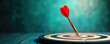 © miss irine - Red dart arrow hits center of bullseye target. Business concept of accurate aiming, goal achievement. Close-up view of traditional dartboard on wooden surface. Winning strategy, success in business.