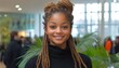 © TeteraX - A cheerful young woman with dreadlocks stands in a bright, vibrant indoor space