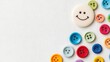 © pinporn manosri - Colorful Buttons and Happy Face on Textured Fabric Background