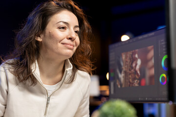 Poster - Happy videographer using professional software to create visual effects for video projects. Smiling expert using post production techniques to edit raw clips footage in home office