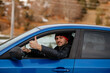 © Dinno - I Like Driving. Smiling caucasin guy sitting inside car and showing thumb up, approving his new vehicle smiling at camera. Happy European man driver renting auto for weekend trip. Young man doing thum