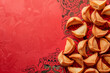 © Duckai - Copy Space Chinese Fortune Cookies on Red Background with Asian Festive Symbols for Lunar New Year 2025 Wooden Snake