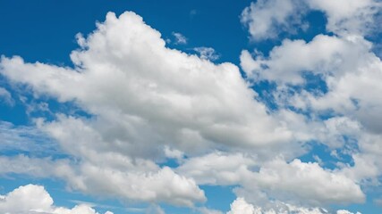 Wall Mural - dynamic time lapse of a clear sky with floating clouds.