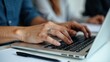 © Abi - Closeup Hands Typing on Laptop Keyboard During Collaborative Office Work