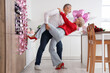 © Pixel-Shot - Happy mature couple dancing in decorated kitchen at home. Valentine's Day celebration