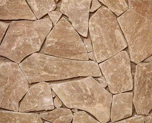 Wall Mural - A wall made of stone with a rough texture