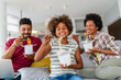 © NDABCREATIVITY - Happy african family eating at living room and enjoying time together. Home delivary takeaway food