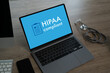 © onephoto - A laptop with the word HIPAA on it a table in hospital