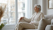 © kazakova0684 - mature wooman holding cane while sitting on sofa in living room