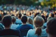 © Vii - A group of people seated in chairs facing the crowd