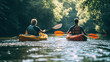© Julie - A couple kayaking on a river, paddles cutting through the water, surrounded by trees and nature.