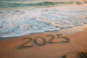 The number '2025' is written in the sand with white waves washing over the shore