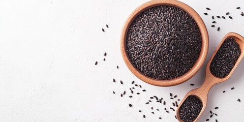 Aufkleber - Uncooked black rice in a bowl, accompanied by a scoop, displayed on a white background a top view showcasing the elegance of uncooked black rice and its rich color.