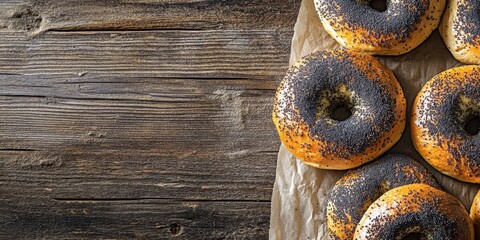 Aufkleber - Fresh homemade bagels with poppy seeds ideal for breakfast, beautifully arranged on a wooden table. Enjoy the appeal of these homemade bagels featuring poppy seeds in every bite.