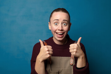 Wall Mural - smiling joyfully and looking happy, feeling carefree and positive with both thumbs up