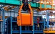 © Chopang.studio - A bright orange industrial magnet hangs from a crane in a warehouse, showcasing heavy lifting equipment in a well-organized storage area.