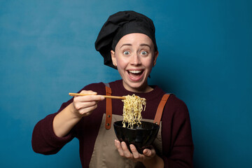 Wall Mural - blonde young pretty chef woman with a ramen bowl