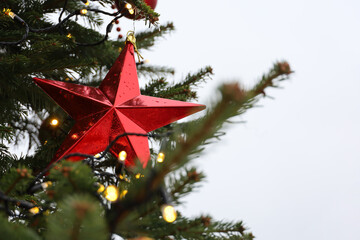 Wall Mural - Red star on a fir branches. New Year tree with decorations