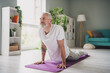 © deagreez - Elderly man practicing yoga in cozy home interior with natural light, promoting healthy lifestyle and wellness