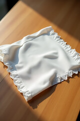 Aufkleber - A napkin or piece of fabric lies on a wooden table with a subtle clipping path for design purposes._00002_