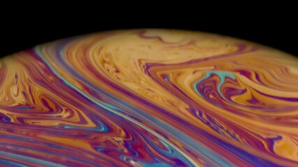 Wall Mural - Closeup video of a soap bubble showing thin film interference concept and the resulting different colors of light with each moving and swirling shapes. Perfect for illustrating concepts of physics.