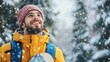 © Napasnan - A cheerful male student holding a snowboard, looking up at the winter sky with excitement, ready for adventure on snowy slopes