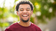 © Paula - Happy man smiling outdoors with green background