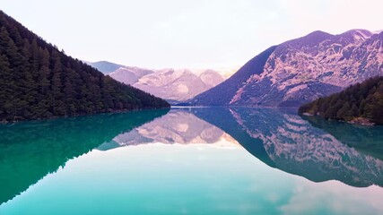 Aufkleber - Scenic lake view reflecting mountains and trees in the early morning sunlight