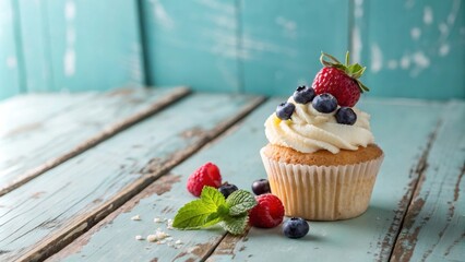 Poster - A Single Cupcake Decorated with Fresh Berries and Whipped Cream on a Rustic Weathered Wooden Surface