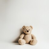 Cute teddy bear on a simple white backdrop, perfect for themes of childhood, comfort, and minimalism.