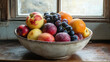 © PiscesserA - A rustic bowl filled with fresh fruit sits on a wooden windowsill bathed in soft light