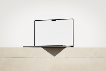 Wall Mural - opened laptop with a blank screen on the light brick podium