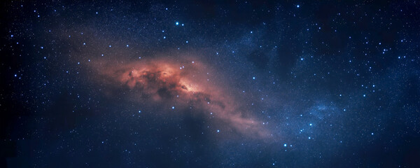 starry sky showcasing the milky way, distant galaxies, and nebulae with orange light illuminating th