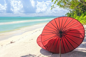 Wall Mural - Relaxing beach scene with a red umbrella under a bright sky and tranquil water