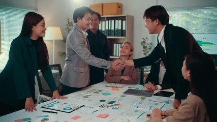 Aufkleber - Diverse group of asian businesspeople clapping and shaking hands, celebrating a successful deal or welcoming a new partner in a bright, modern office