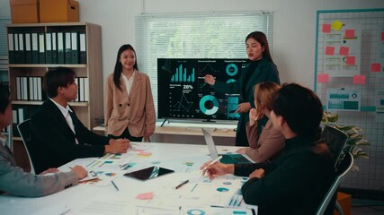 Aufkleber - Skilled businesswomen presenting financial results using a monitor to colleagues in a modern office, fostering collaboration and strategic decision-making