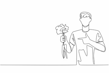 Poster - single one line drawing man holding some carrots with the tips of the leaves still thick. plays role