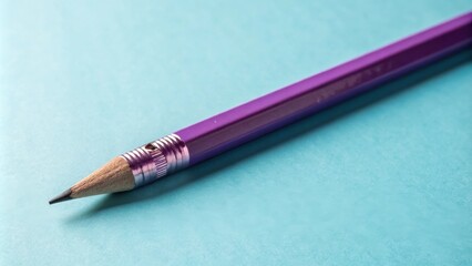 Aufkleber - A Sharpened Purple Pencil Lies on a Blue Surface, Ready to Be Used for Writing or Drawing