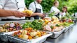 © kinara art design - Chefs preparing gourmet food in disposable containers for catering event.