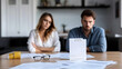 © Xinfang - selective focus of couple sitting at table with divorce documents
