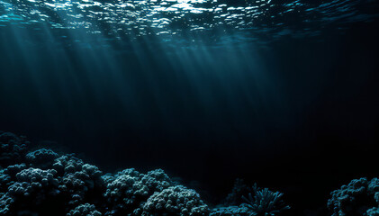 Wall Mural - Underwater scene with coral reef and sunlight beams penetrating the dark blue water.