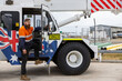 © Austockphoto - Young adult machinery driver worker climbing into crane